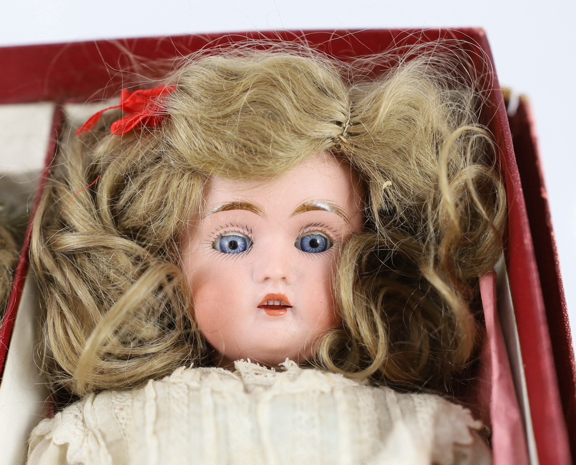 A rare J. D. Kestner bisque character doll, with three interchangeable character heads, German, circa 1910, overall 28cm high, retaining original instructions of how to change heads and the original box